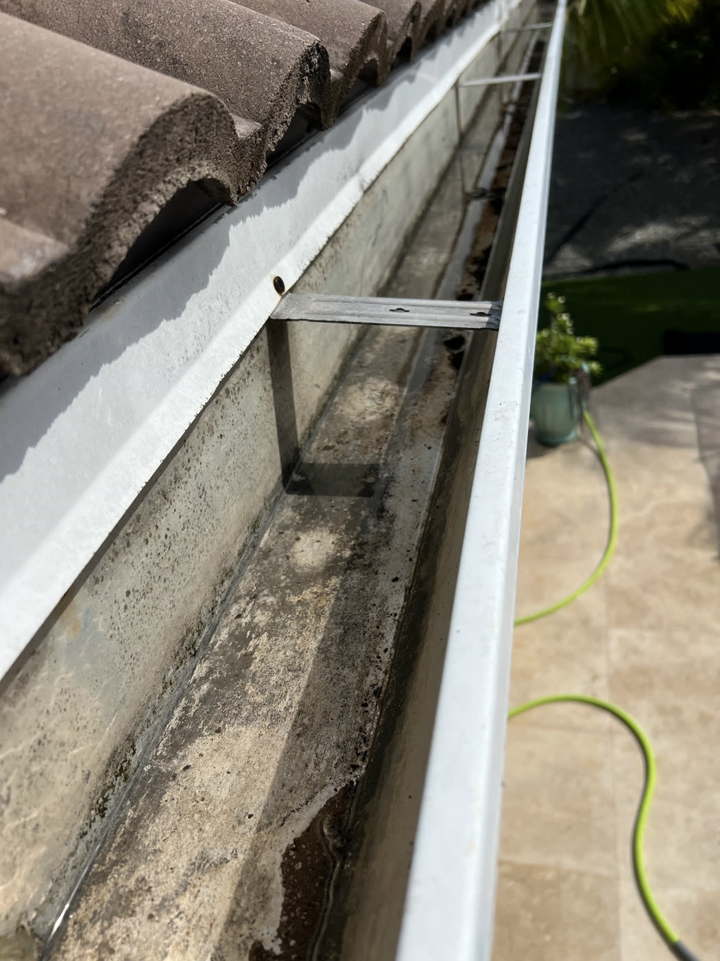 7 tennis balls in one downspout — Gutter flush, by Cayman Clean & Blast, Grand Cayman